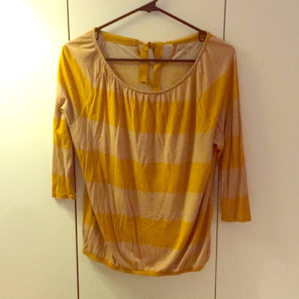 3/4 sleeve top with bow tie in the back.